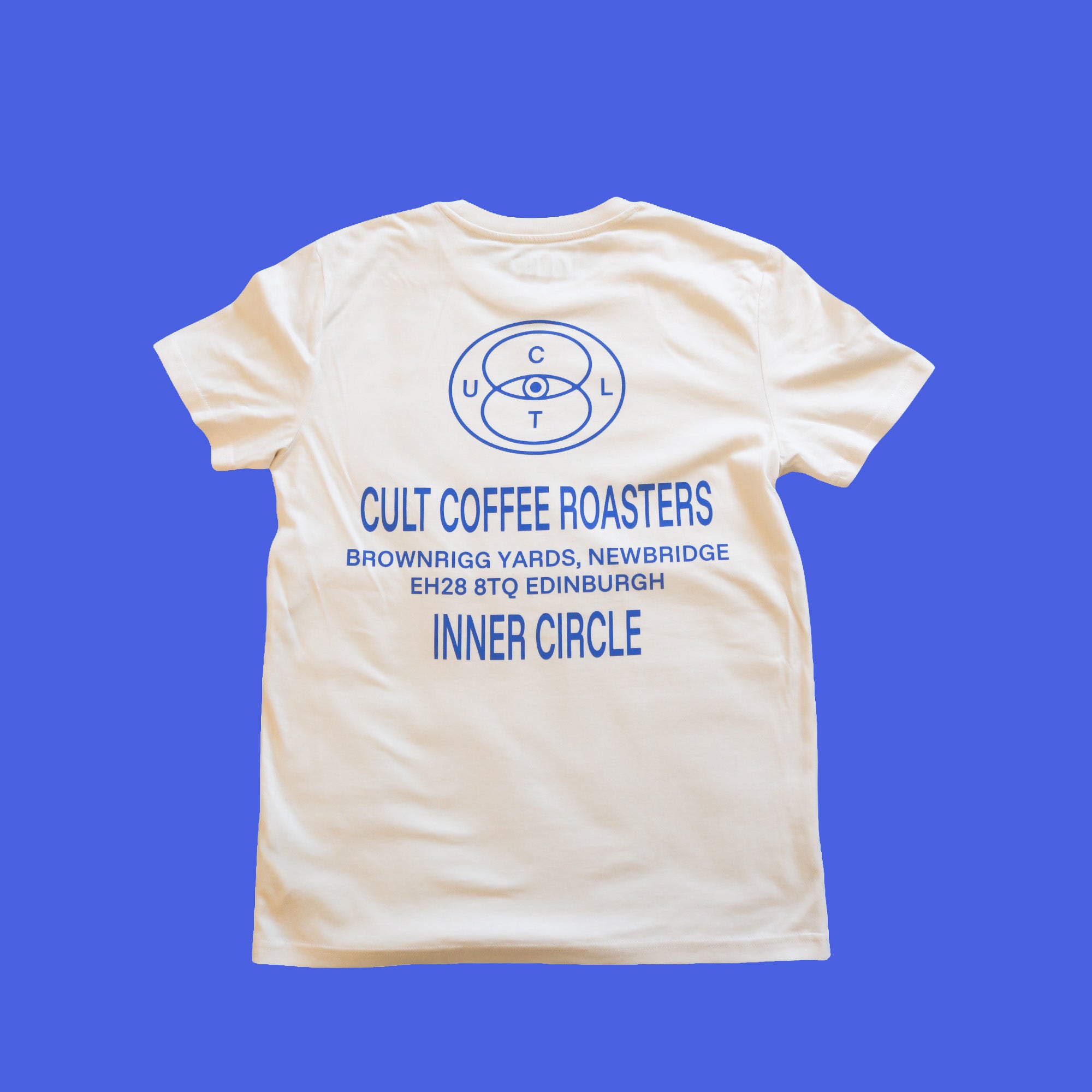 Cream t-shirt on blue background with blue writing reading: Cult Coffee Roasters, Brownrigg Yards, Newbridge, Edinburgh. Says 'Inner Circle' at the bottom